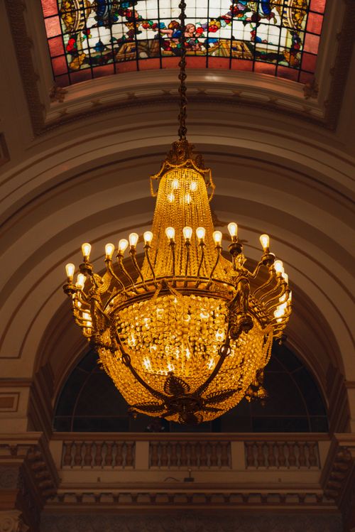 Free Majestic chandelier in a historic Lima palace with stained glass details. Stock Photo