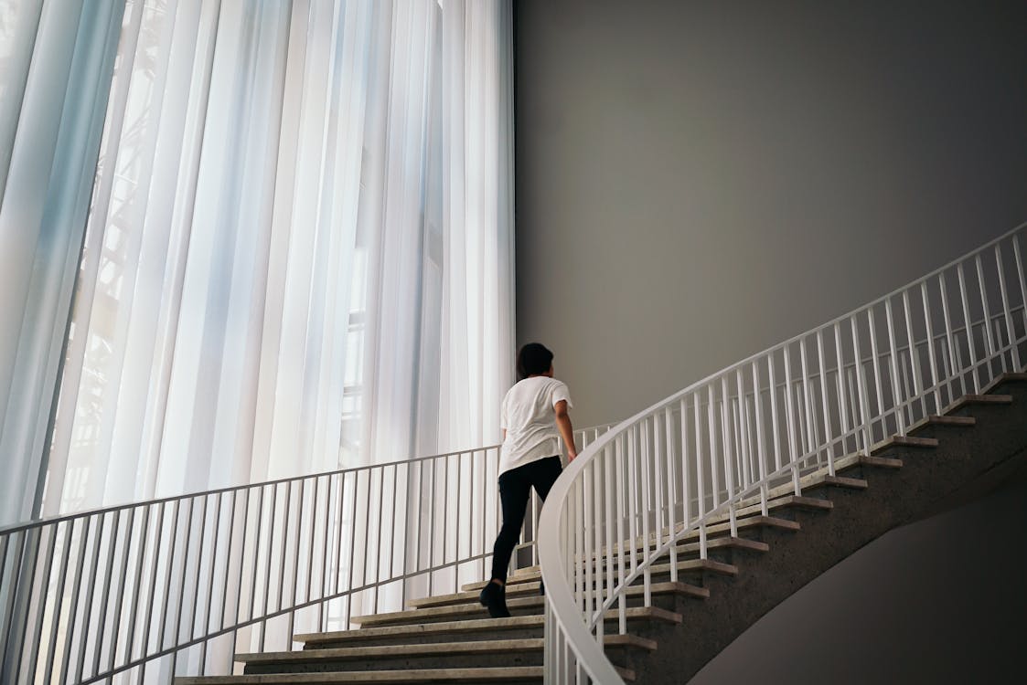 Free Person Walking On Stairs Inside Building Stock Photo