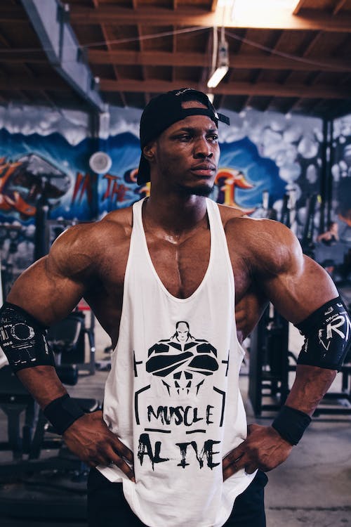 Muscular Man Posing in Gym · Free Stock Photo