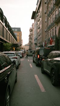 View of a city street with cars and pedestrians, capturing urban life.