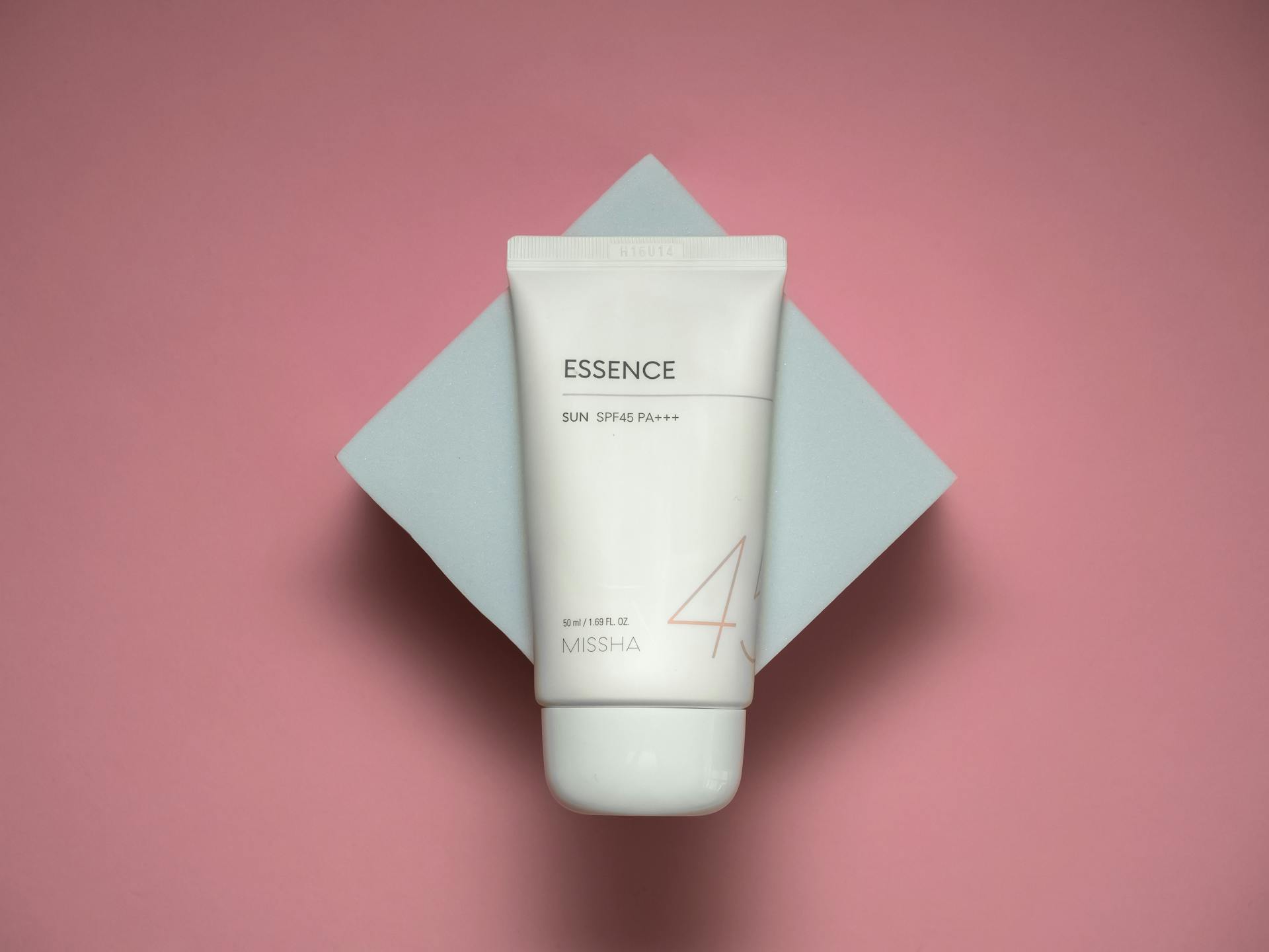 Studio shot of luxury sun cream with SPF45 on a stylish pink background.