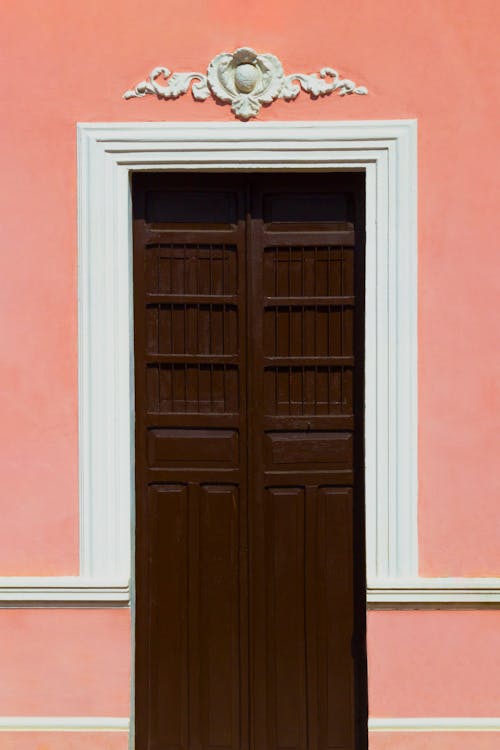 Wooden Door in a Pink Building 