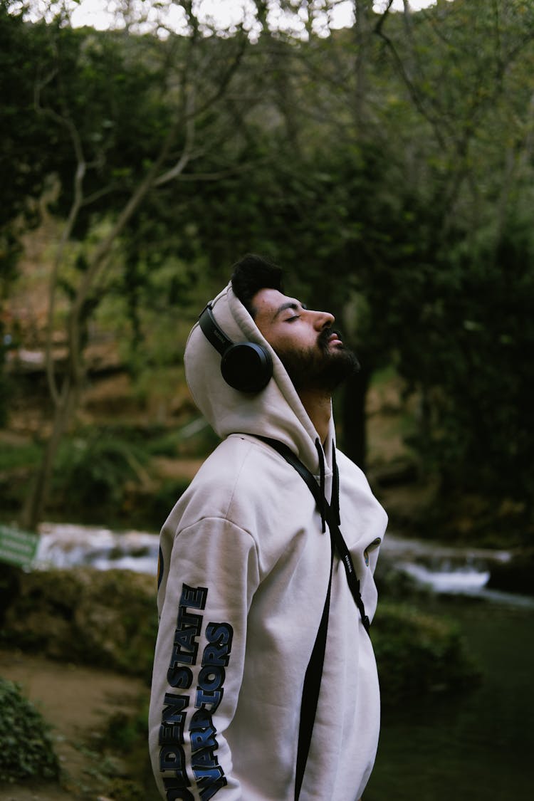 Young Man In A Hoodie Listening To Music