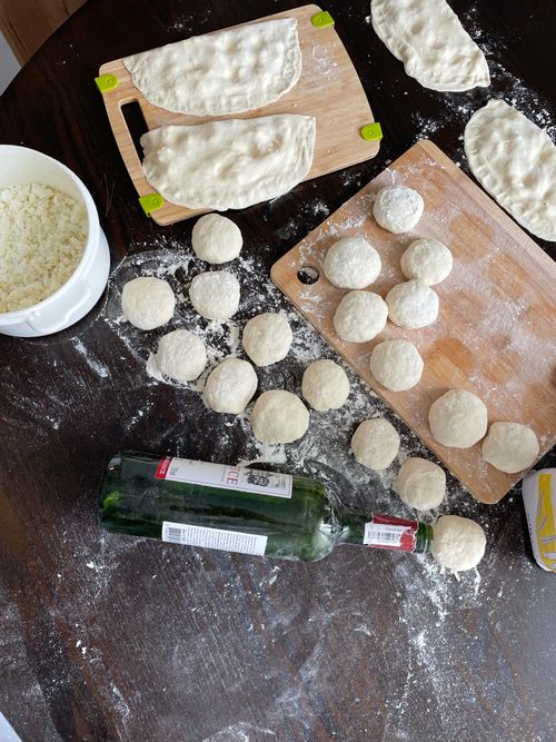 Free Overhead view of dough preparation for dumplings on wooden boards in a cozy kitchen setting. Stock Photo