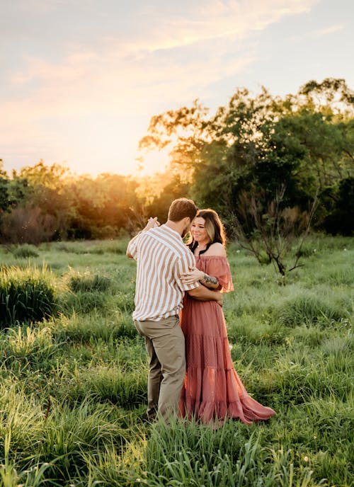 Couple Together on Field at Sunset