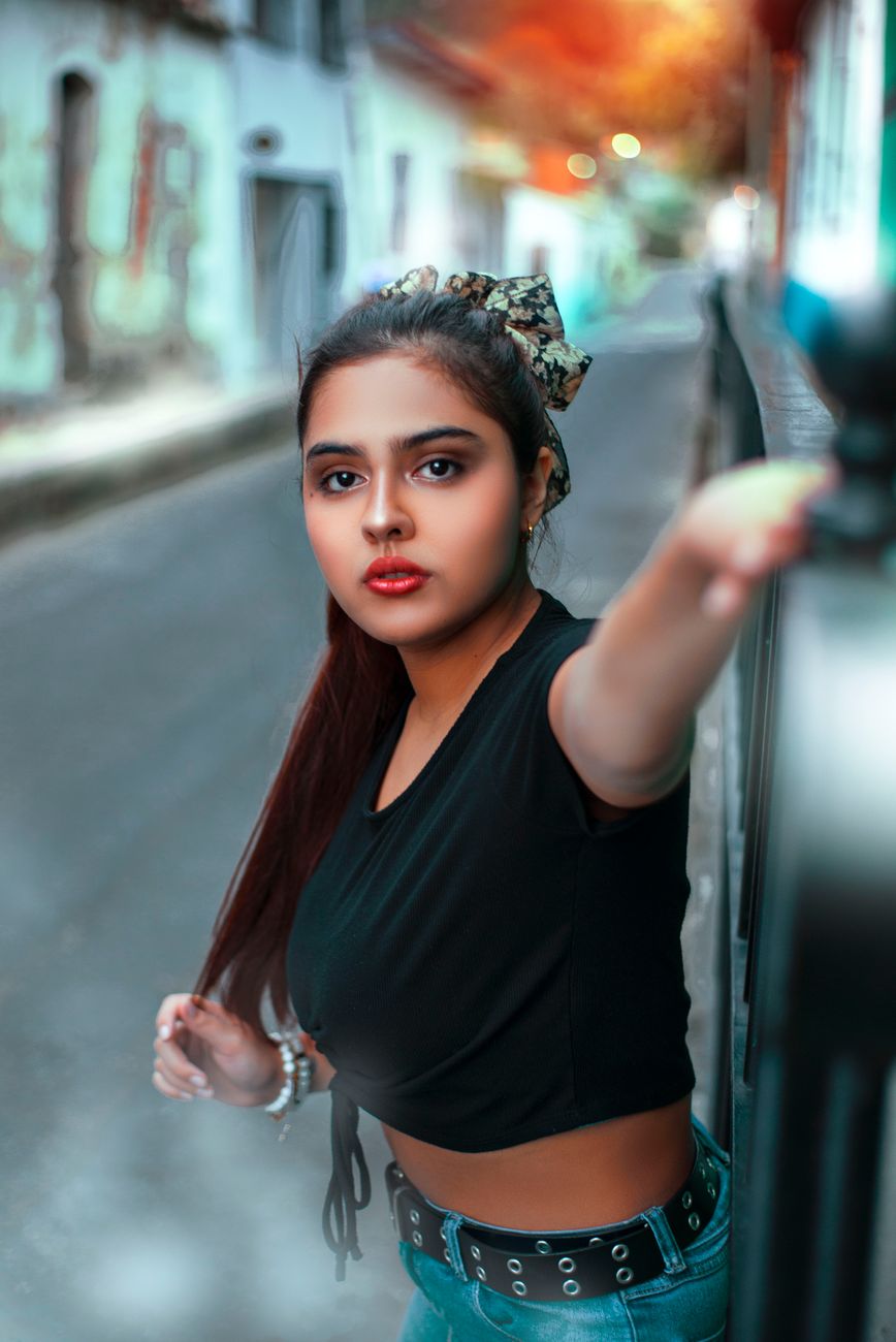 A fashionable woman posing confidently on a vibrant street in Caracas, Venezuela. Captivating urban