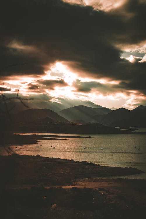 Silhouetted Mountains on the Coast under a Dramatic Sunset Sky 