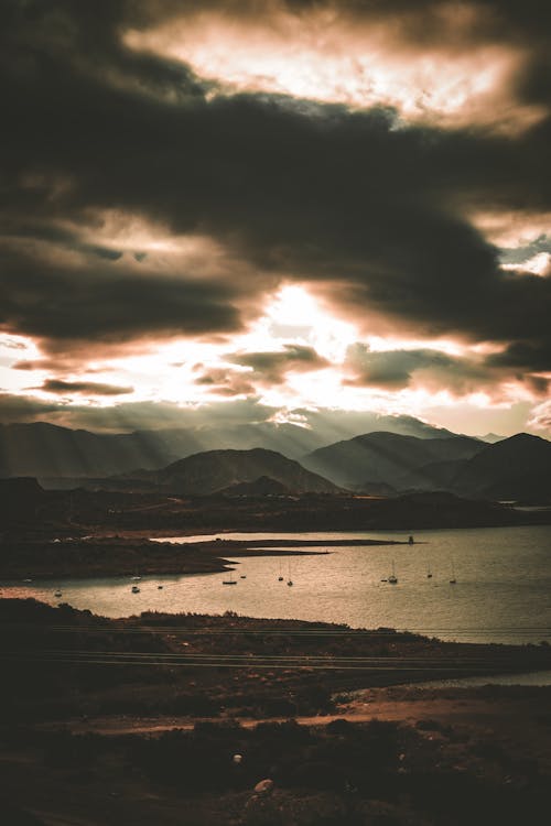 Silhouetted Mountains on the Coast under a Dramatic Sunset Sky 