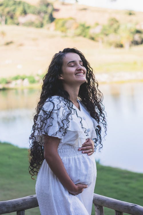 Pregnant Woman in White Dress