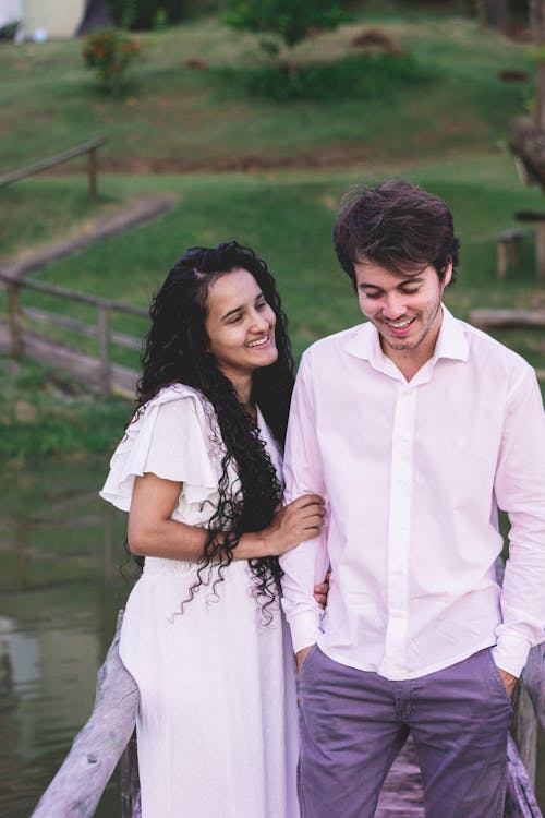 Young Couple Standing and the Bridge and Laughing 