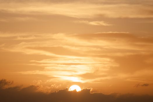 A breathtaking golden sunrise over clouds, capturing the serene beauty of Kailua-Kona, Hawaii.