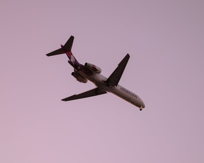 Photo by Josh Withers Hawaiian airline plane captured flying against a clear dusk sky in Kailua-Kona, Hawaii.