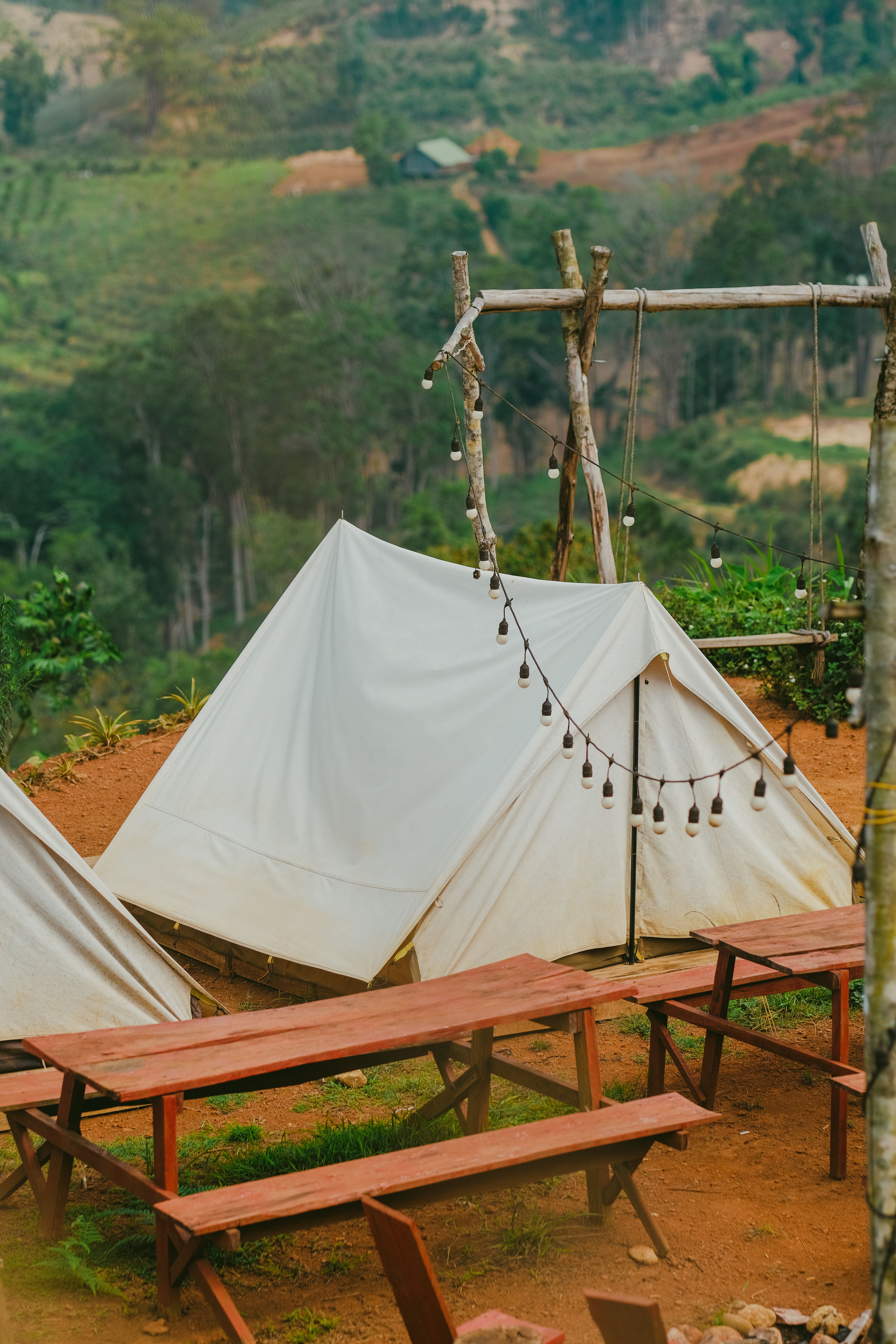 A cozy yurt at a wooded campground near Niagara with a picnic table and string lights