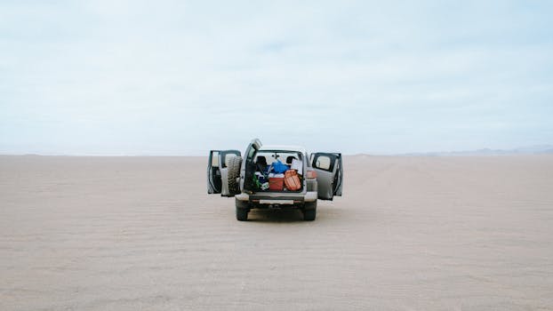 A 4x4 vehicle in the vast Ica desert, Peru, ideal for off-road travel and adventure.