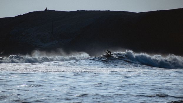 A lone surfer conquering waves at Punta Hermosa, Lima Province, Peru.