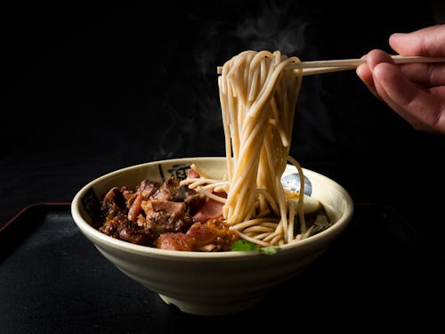 Eating Beef Noodle Soup with Chopsticks