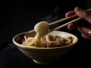 Bowl of ramen with chopsticks — photo by Luis C. Tavera on Pexels