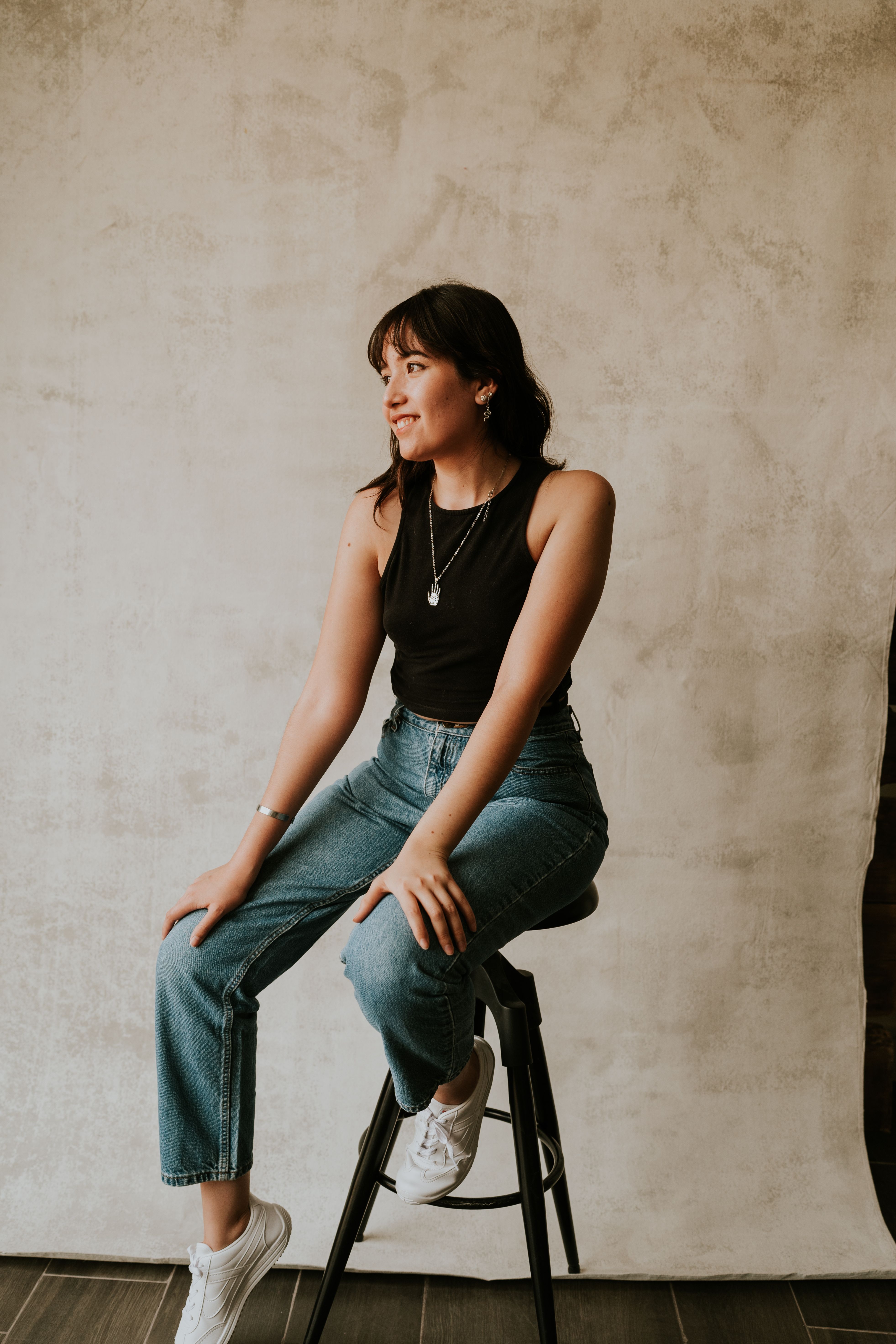 Woman in Blue Jeans Sitting on the Stool · Free Stock Photo