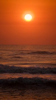 Dramatic sunset casting golden hues over a serene ocean horizon. Perfect for travel and nature themes.
