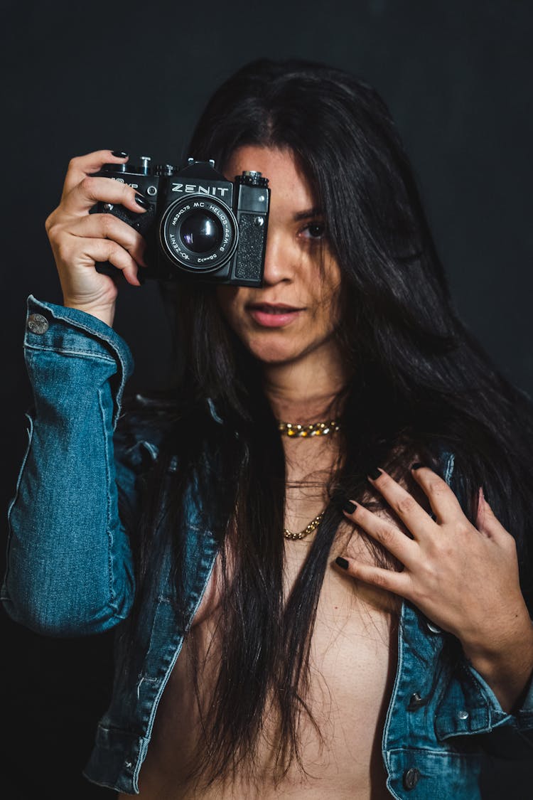 Brunette Woman In Jean Jacket And With Camera