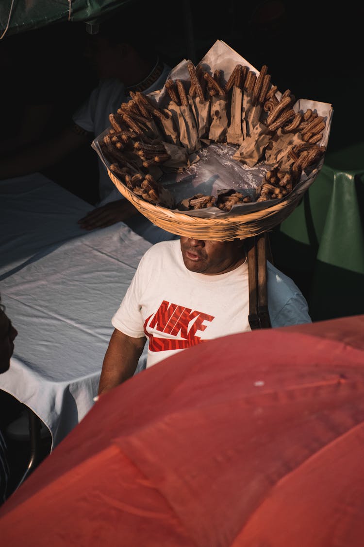 Merchant Carrying Basket Of Snacks On Head