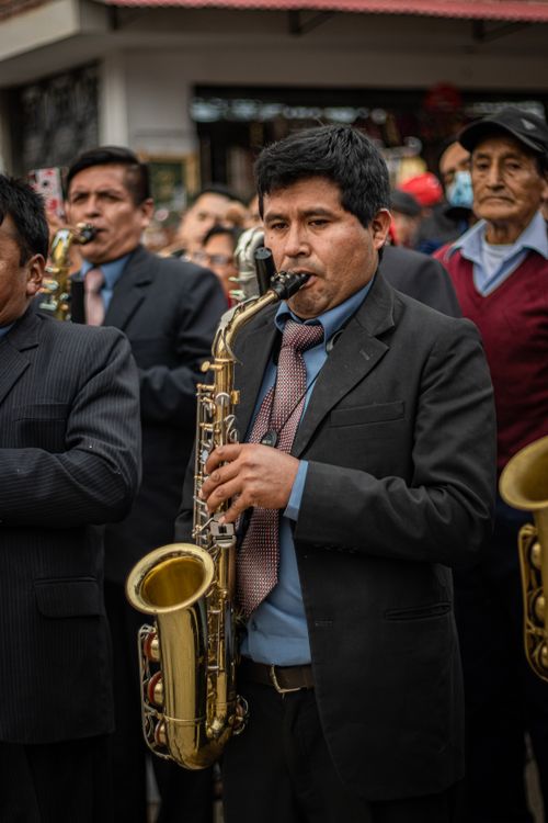 Free Brass musicians playing saxophones on city streets during a cultural event in Muruhuay, Peru. Stock Photo