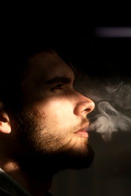 Backlit profile exhaling smoke, photo by Alimurat Ural on Pexels