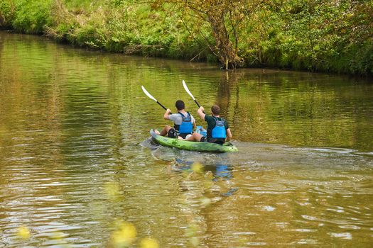 Rowers in a Kayak on the River
