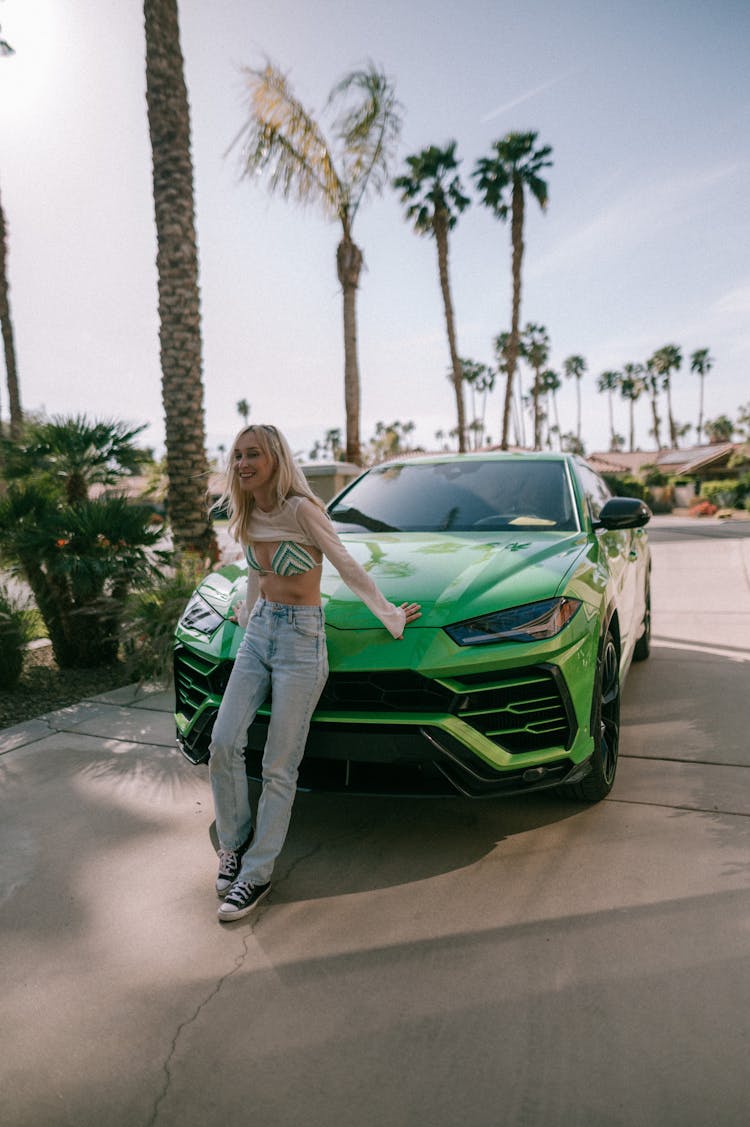 Blonde Woman Posing By Green Car