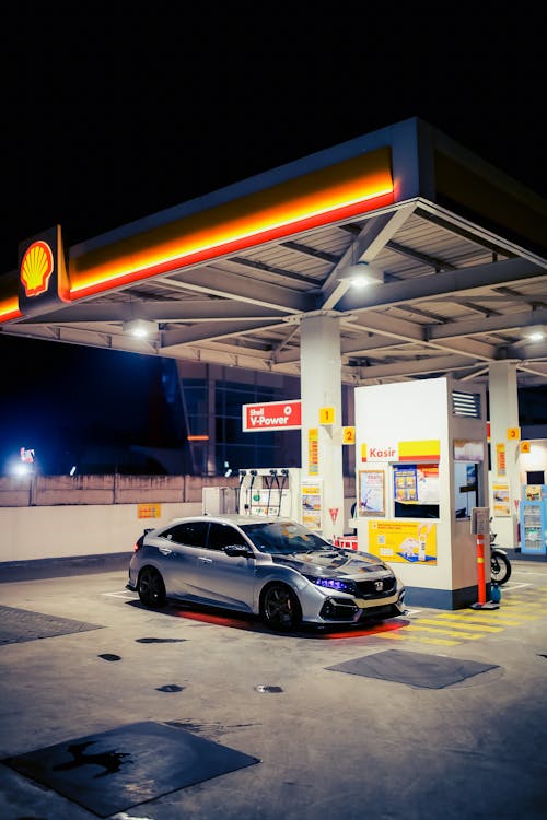 Silver Honda Civic at a Shell Gas Station at Night