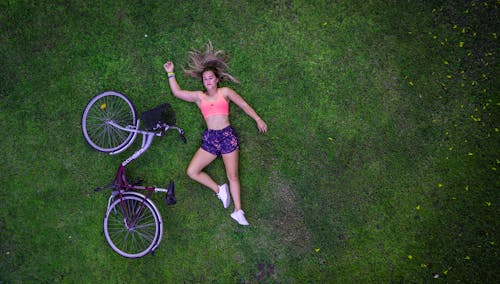 Top View Photo of Woman Lying On Grass