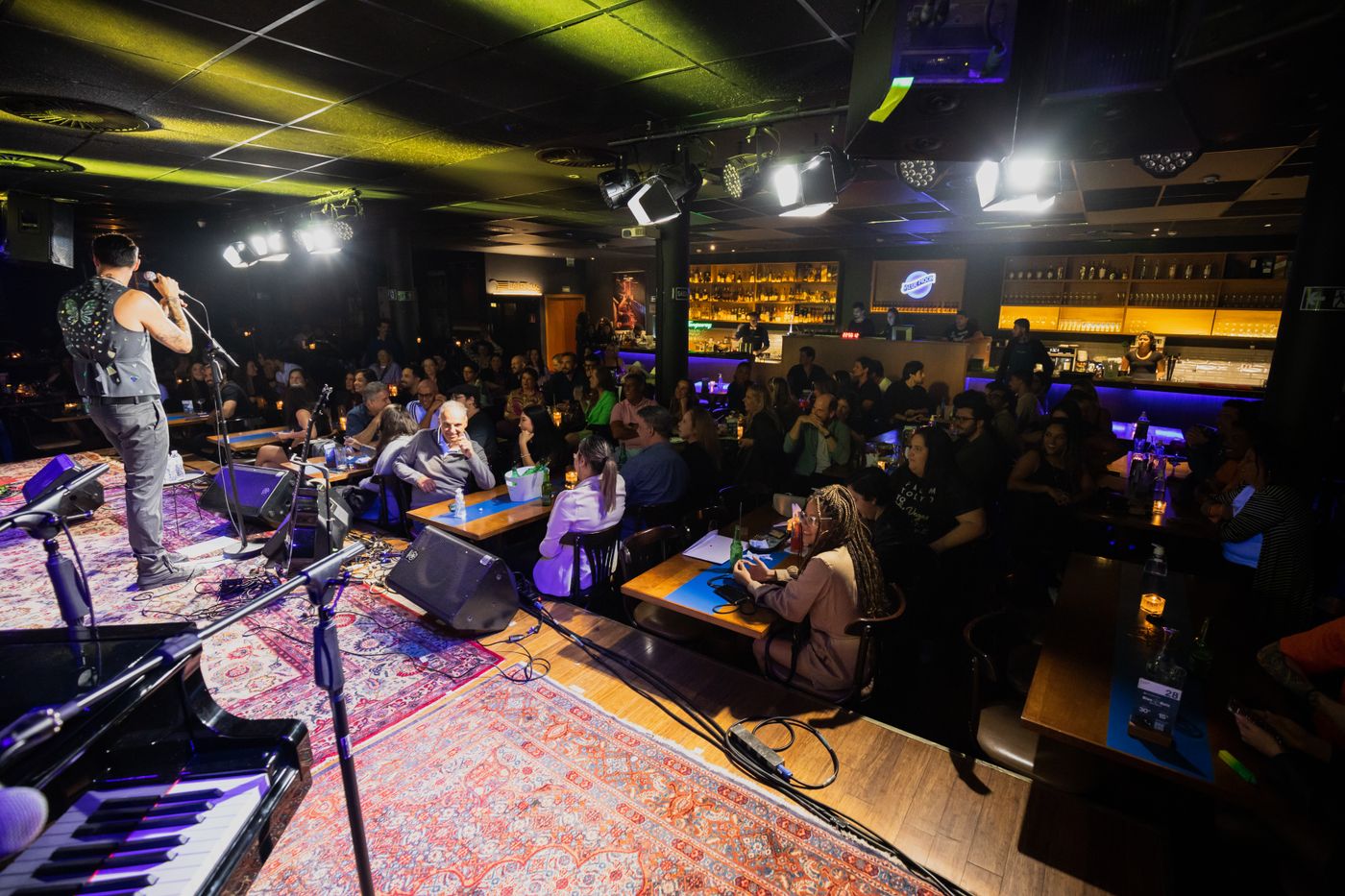 Musician performing live inside a lively pub setting