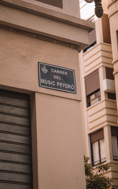 Free Carrer del Músic Peydró street sign in Valencia, Spain, highlighting modern urban architecture. Stock Photo