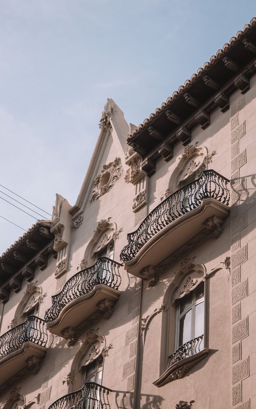Free Low angle view of a historic building with ornate balconies in Valencia, Spain. Stock Photo