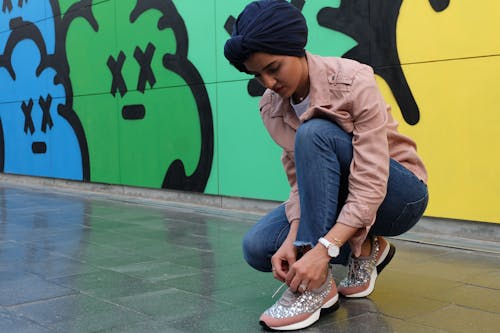 Photo of Woman Tying Her Shoes