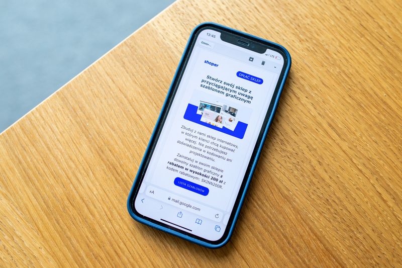 Smartphone displaying website on wooden surface