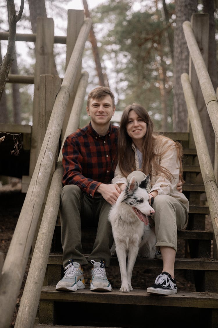 Woman And Man Posing Together With Dog