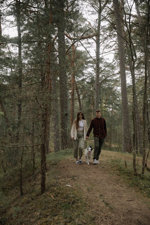 Couple Walking with Dog in Forest