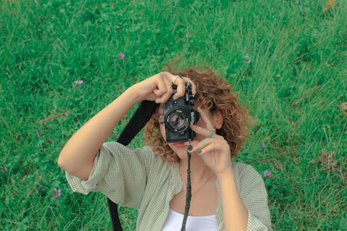 Young Woman Taking Pictures with a Vintage, Film Camera 