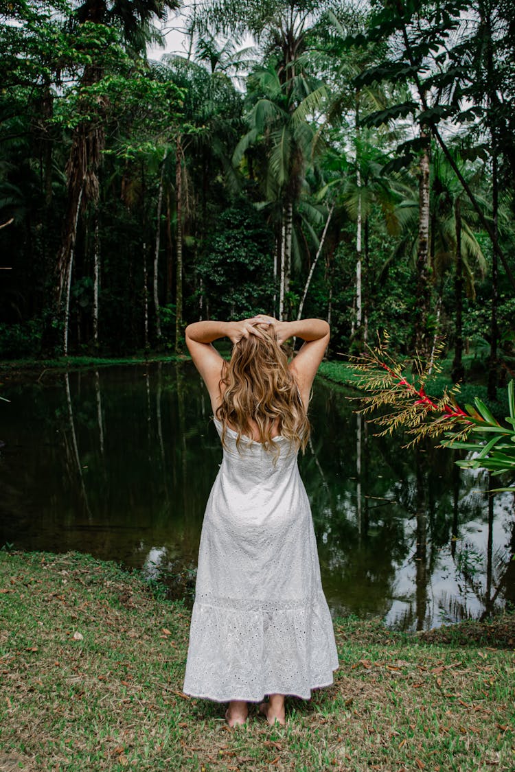 Woman Standing And Looking At The View Of A River 