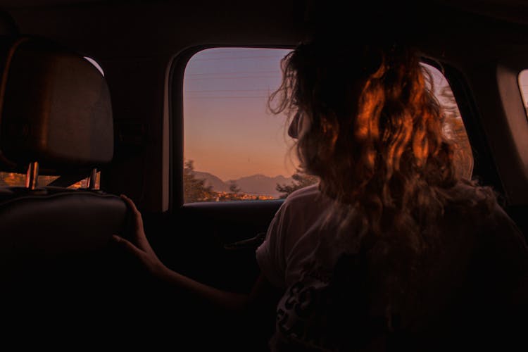 Woman In Car At Sunset