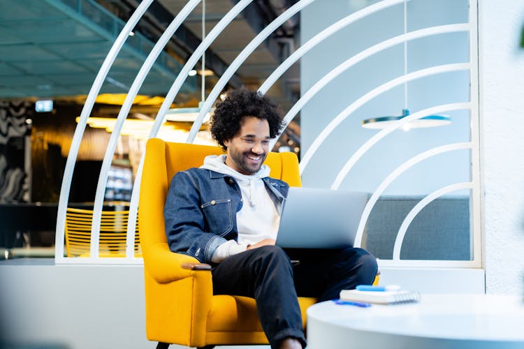 Smiling Man Working On Laptop