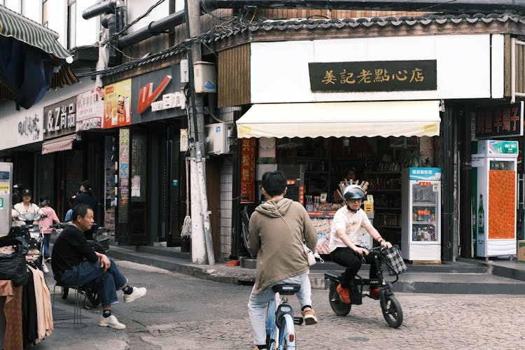 Men Riding Motorbikes In A City In Japan 