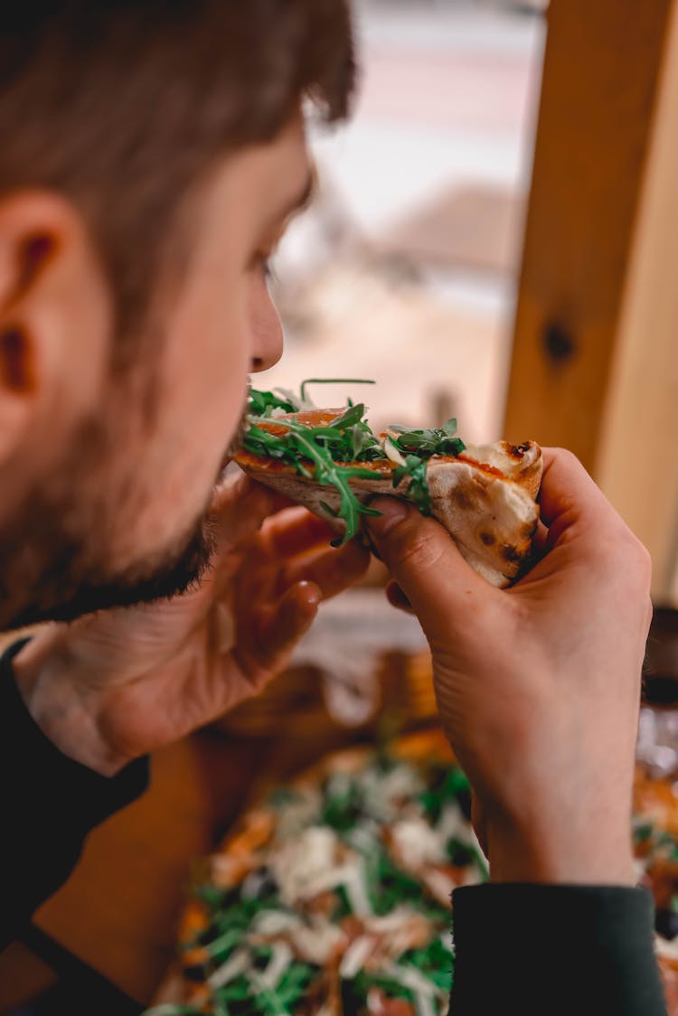 A Man Eating Pizza