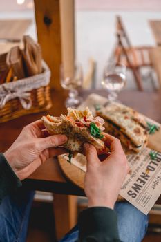 Delicious panini sandwich being enjoyed in a cozy café. Warm, inviting dining atmosphere.