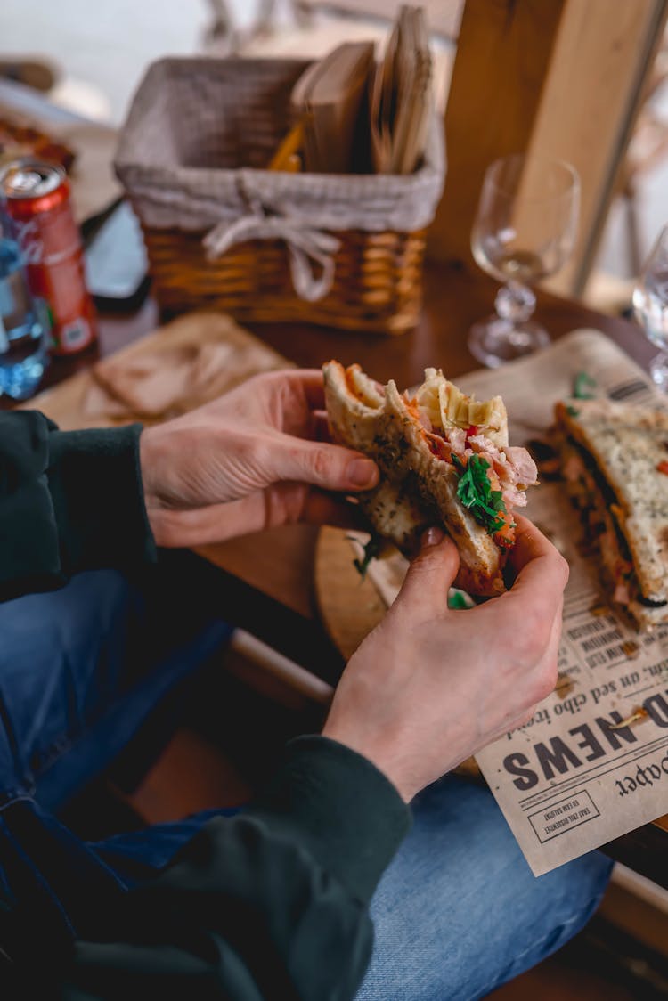 Man Eating A Sandwich At The Restaurant 