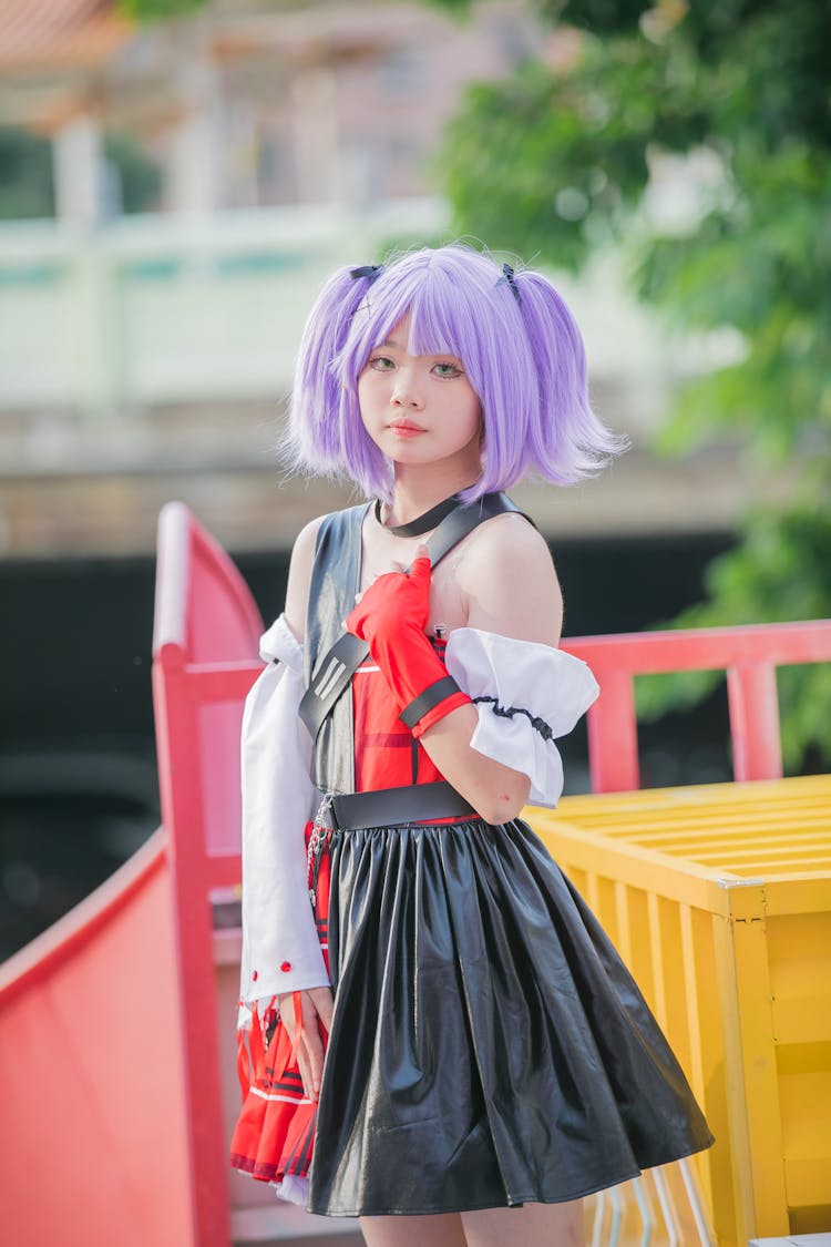 Teenager Girl Posing In Purple Wig And Manga Character Costume