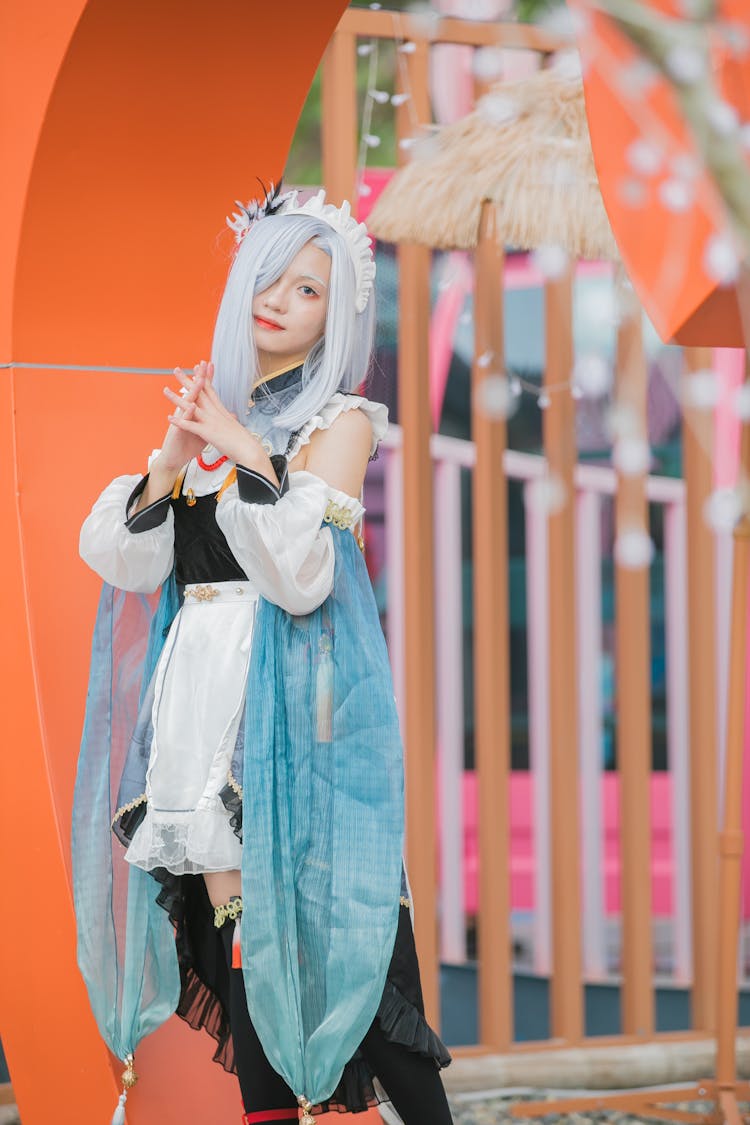 Teenage Girl Posing In Light Blue Wig And Costume Of A Video Game Character