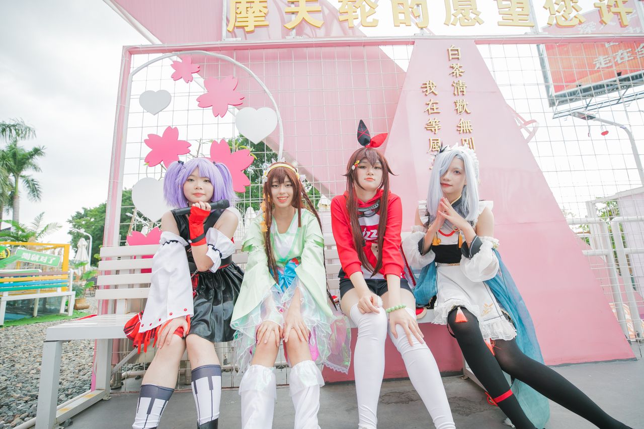 group of cosplayers in colorful costumes posing outdoors at a festival