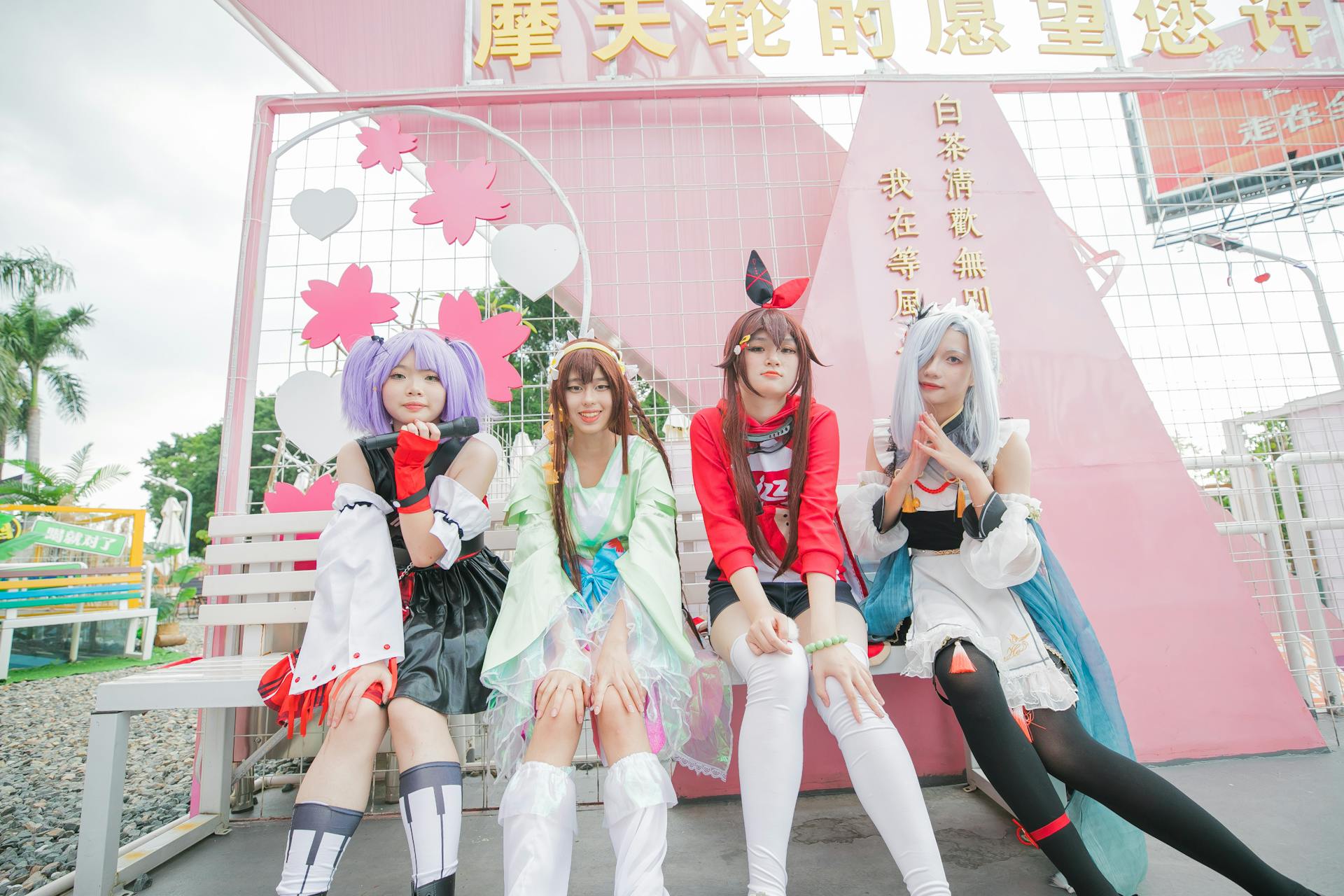 Group of Teenager Girls Posing in Bright Costumes of Manga Characters